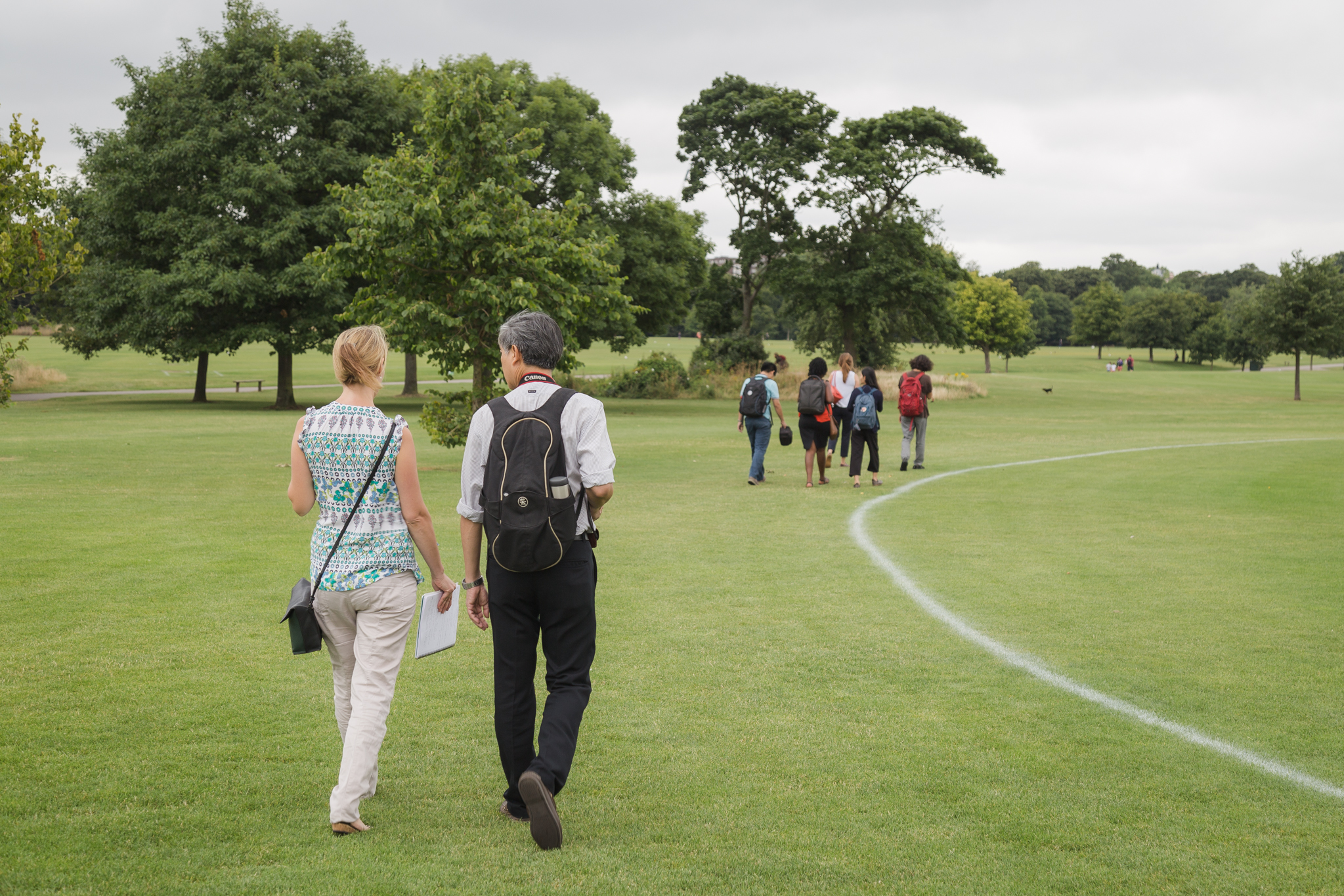 Research team walking meeting through park in London